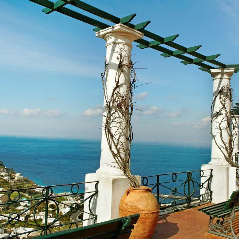 White columned pergola terrace in Anacapri overlooking the blue Bay of Naples