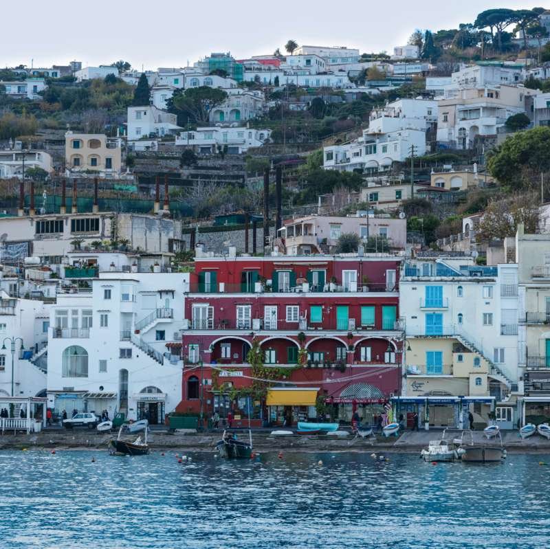 Red and white houses of Marina Grande waterfront on Capri seen from the sea