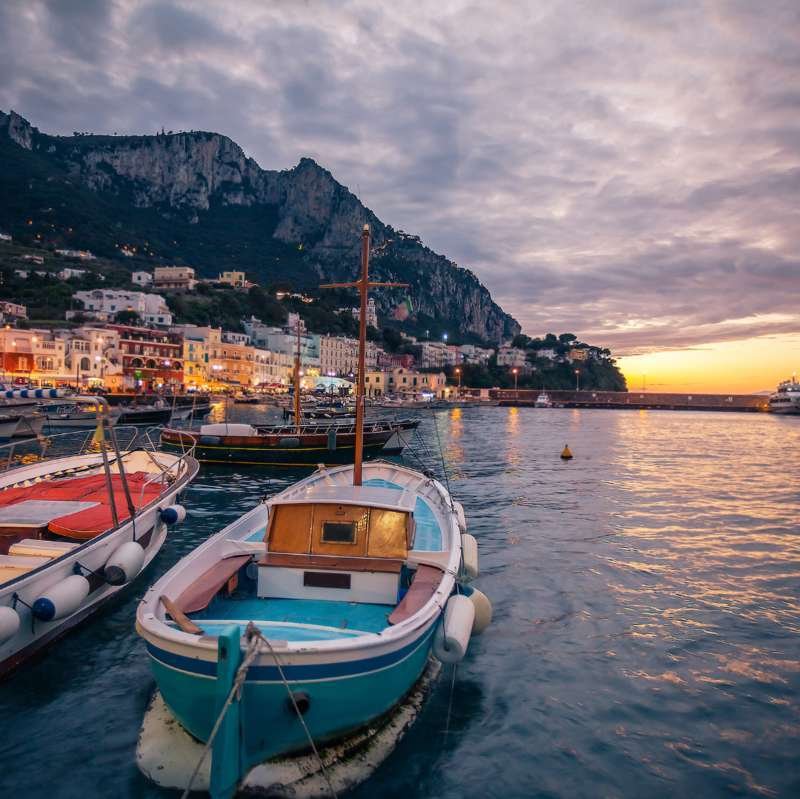 Wooden boats in Marina Grande harbor on Capri at sunset